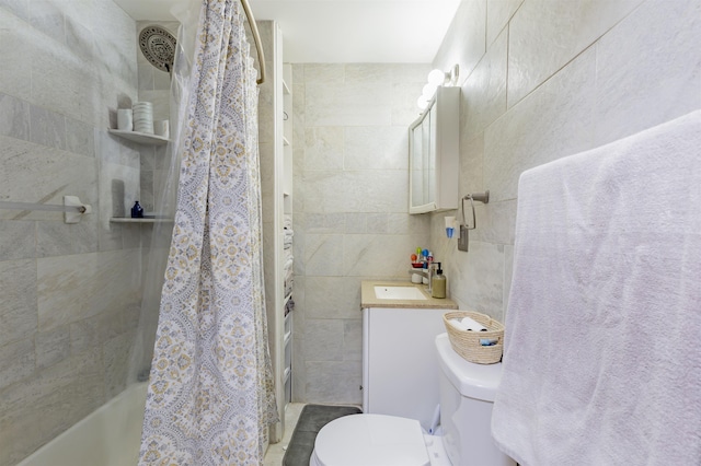 bathroom featuring vanity, shower / bath combo with shower curtain, toilet, and tile walls