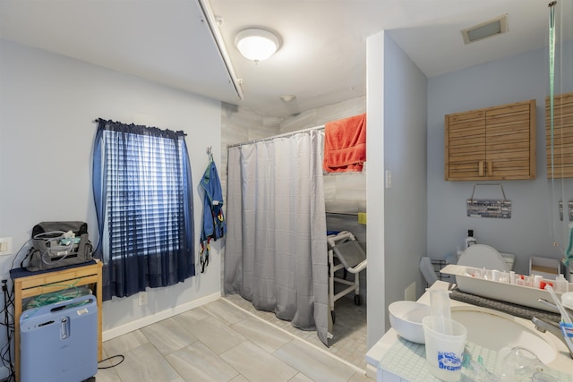 bathroom with visible vents and curtained shower