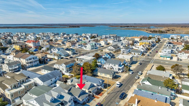 birds eye view of property with a water view and a residential view