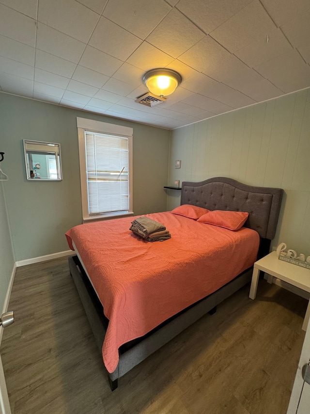 bedroom featuring wood finished floors and baseboards