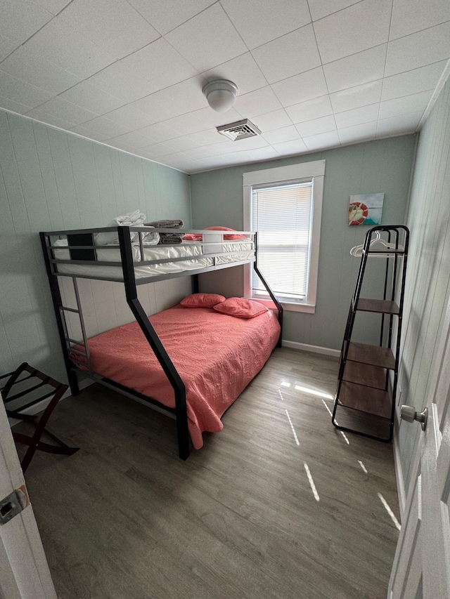 bedroom with wood finished floors and baseboards