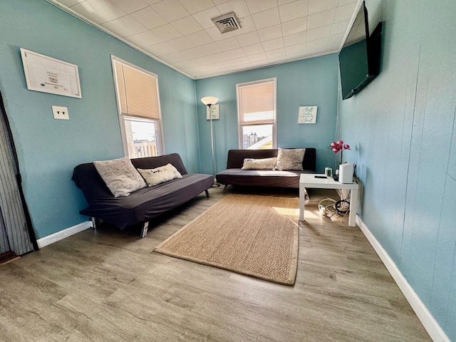 sitting room with healthy amount of natural light, wood finished floors, and baseboards