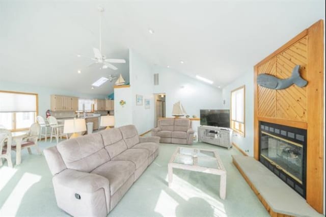 141 8th St, Avalon, NJ 08202 - living area featuring a glass covered fireplace, ceiling fan, light carpet, and high vaulted ceiling