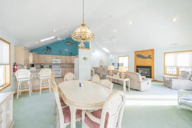 141 8th St, Avalon, NJ 08202 - dining space with ceiling fan, light carpet, a large fireplace, and high vaulted ceiling
