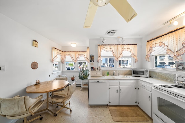 396 95th St, Stone Harbor, NJ 08247 - kitchen with white appliances, light countertops, white cabinets, and light flooring