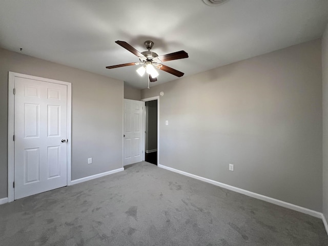 unfurnished bedroom featuring ceiling fan and carpet floors