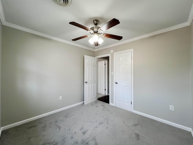 unfurnished bedroom featuring ornamental molding, carpet floors, and ceiling fan