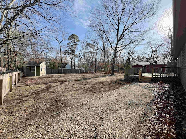 view of yard with a storage shed and a deck