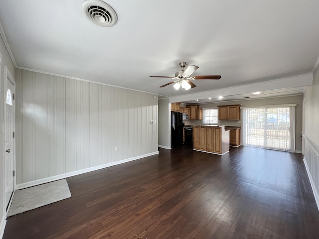 unfurnished living room with crown molding, ceiling fan, and dark hardwood / wood-style flooring