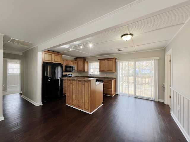 kitchen featuring a kitchen island, dark hardwood / wood-style floors, sink, and black appliances