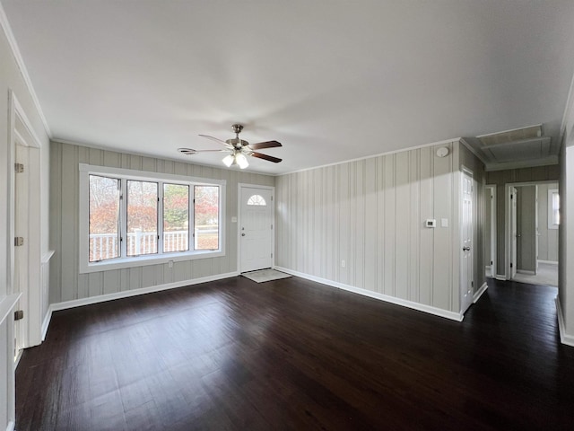 empty room with dark wood-type flooring, ornamental molding, and ceiling fan