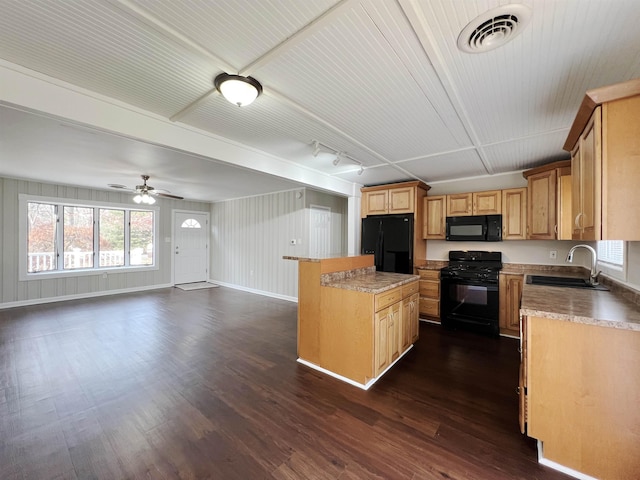 kitchen with dark hardwood / wood-style floors, light brown cabinetry, sink, a center island, and black appliances