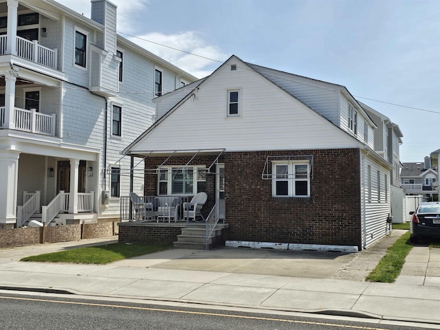 408 E 7th Ave, North Wildwood, NJ 08260 - view of front of property with a chimney, a porch, and brick siding