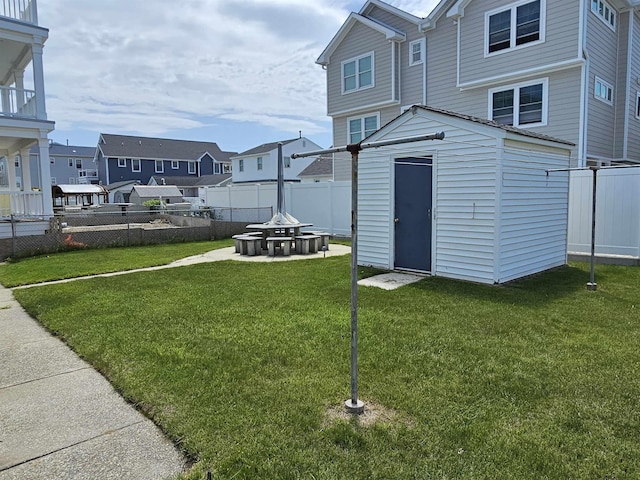 408 E 7th Ave, North Wildwood, NJ 08260 - view of yard featuring an outbuilding, a residential view, a fire pit, a fenced backyard, and a storage unit