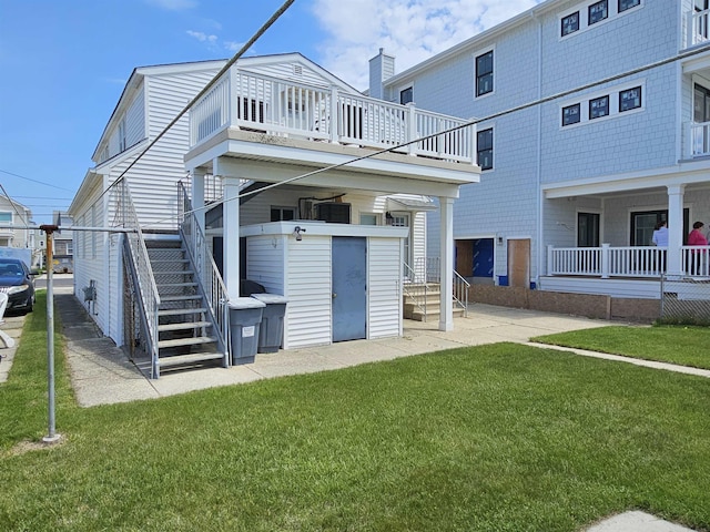 408 E 7th Ave, North Wildwood, NJ 08260 - rear view of house featuring stairway and a lawn