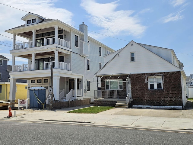 408 E 7th Ave, North Wildwood, NJ 08260 - view of front of house with a porch and brick siding