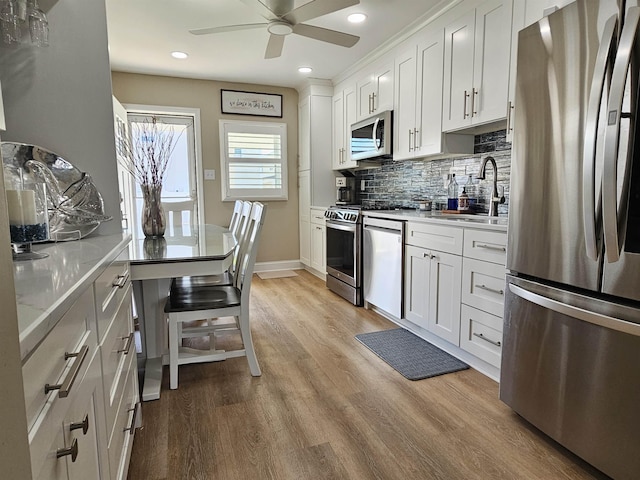 408 E 7th Ave, North Wildwood, NJ 08260 - kitchen featuring backsplash, light countertops, appliances with stainless steel finishes, and a sink