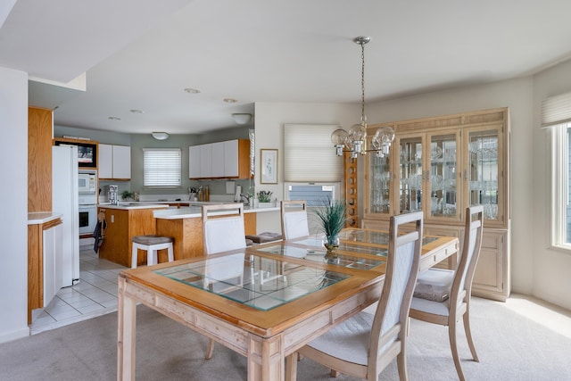53 E 25th St, Avalon, NJ 08202 - dining room with light colored carpet, a chandelier, and light tile patterned floors