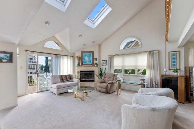 53 E 25th St, Avalon, NJ 08202 - living room featuring a fireplace, carpet, high vaulted ceiling, a skylight, and plenty of natural light