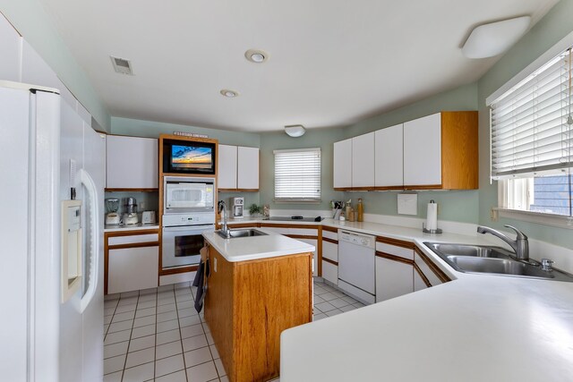 53 E 25th St, Avalon, NJ 08202 - kitchen with white appliances, light countertops, an island with sink, white cabinetry, and light tile patterned floors