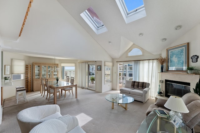 53 E 25th St, Avalon, NJ 08202 - living room featuring light colored carpet, high vaulted ceiling, a skylight, a glass covered fireplace, and plenty of natural light