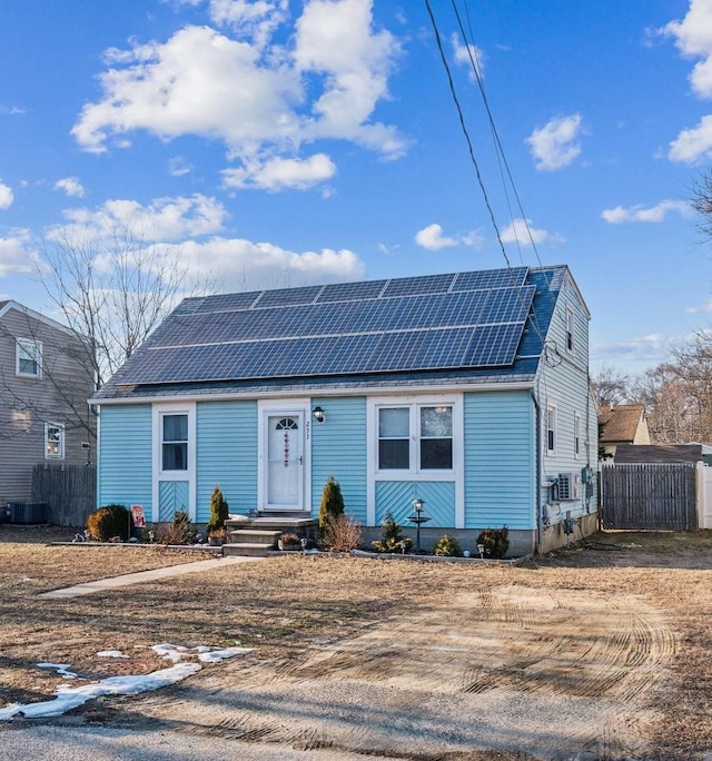 view of front facade with central AC unit and solar panels