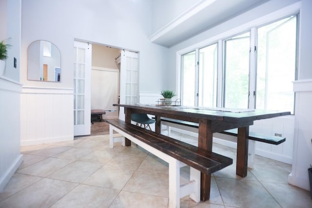14 Freedom Dr, Erma, NJ 08204 - dining area with wainscoting, light tile patterned floors, and a decorative wall