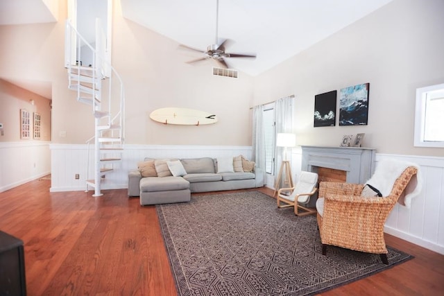 14 Freedom Dr, Erma, NJ 08204 - living room with stairs, wood finished floors, a ceiling fan, a wainscoted wall, and a fireplace