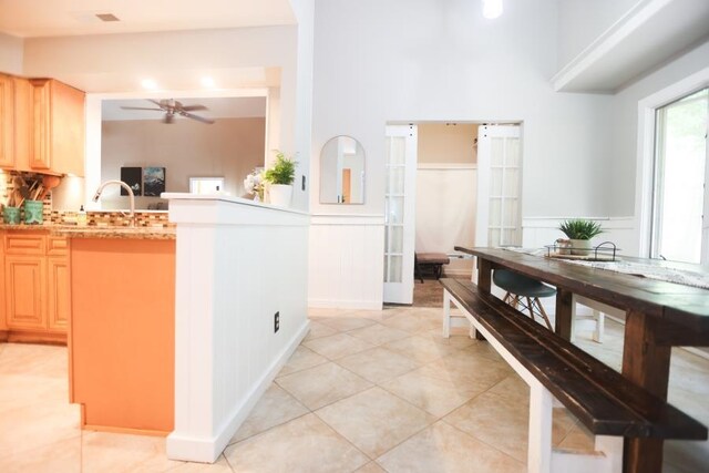 14 Freedom Dr, Erma, NJ 08204 - kitchen with light brown cabinetry, light countertops, a ceiling fan, wainscoting, and light tile patterned floors