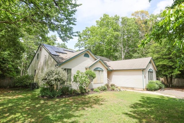 14 Freedom Dr, Erma, NJ 08204 - view of front of house with roof mounted solar panels, central AC, and roof with shingles