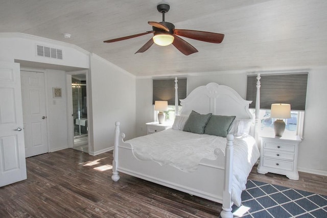 bedroom featuring multiple windows, dark hardwood / wood-style floors, vaulted ceiling, and ceiling fan