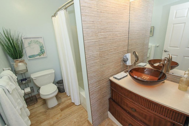 full bathroom featuring shower / bath combo with shower curtain, vanity, and toilet