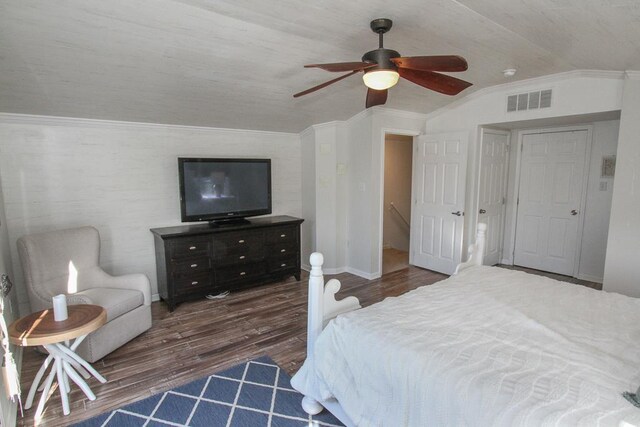 bedroom with dark hardwood / wood-style flooring, vaulted ceiling, ceiling fan, and crown molding