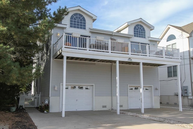 view of front of property featuring a balcony and a garage