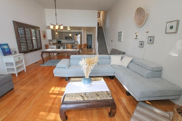 living room featuring wood-type flooring and vaulted ceiling