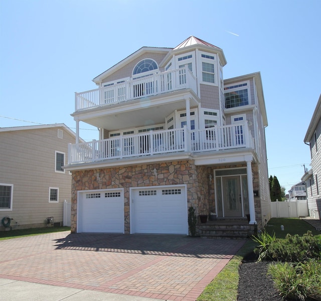 view of front facade featuring a balcony and a garage