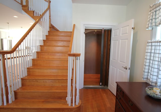 staircase with wood-type flooring