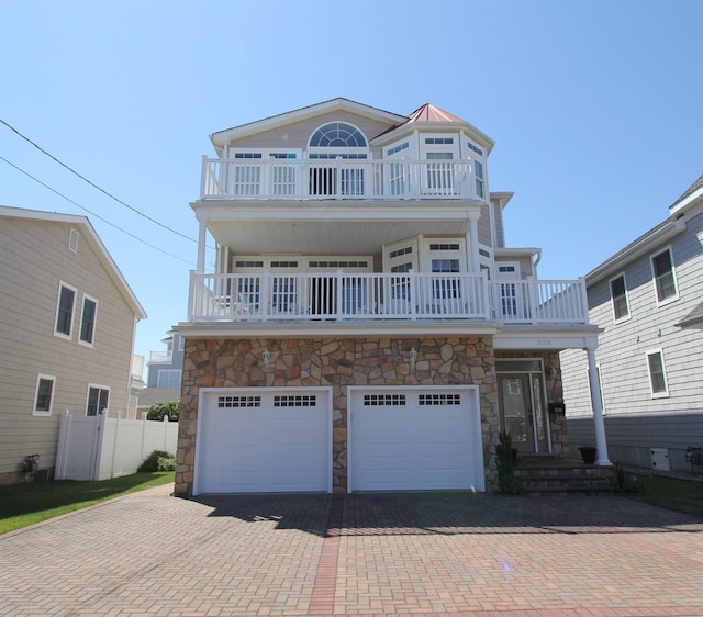 view of front of home with a balcony and a garage