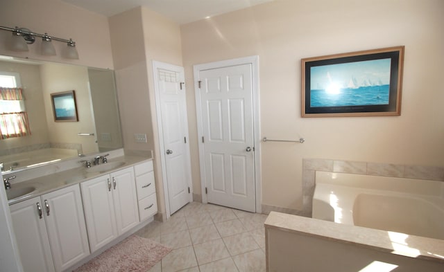 bathroom featuring tile patterned floors, vanity, and a tub to relax in