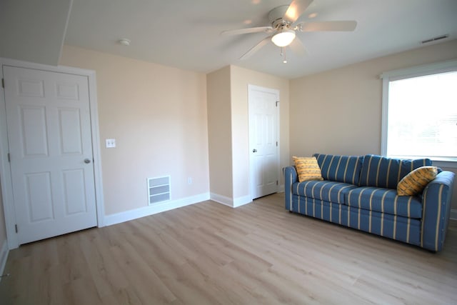 living room featuring ceiling fan and light wood-type flooring