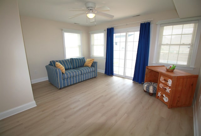 living area featuring ceiling fan and light hardwood / wood-style flooring