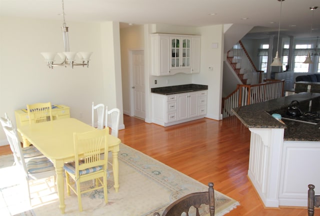 dining space featuring light hardwood / wood-style flooring and an inviting chandelier