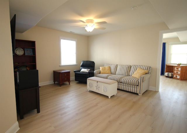 living room with ceiling fan and light wood-type flooring