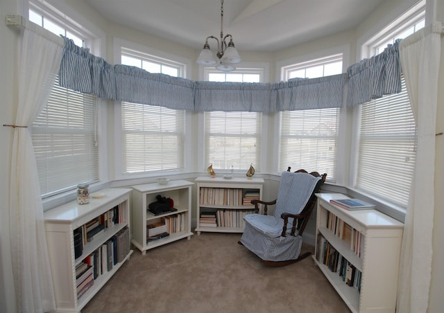 sitting room with carpet, a high ceiling, and an inviting chandelier