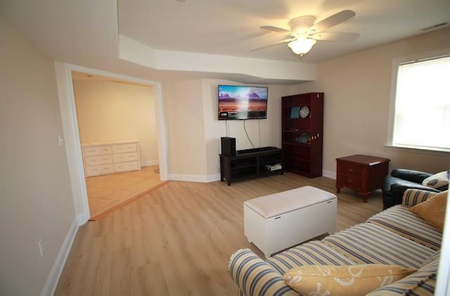 living room featuring ceiling fan and light hardwood / wood-style floors