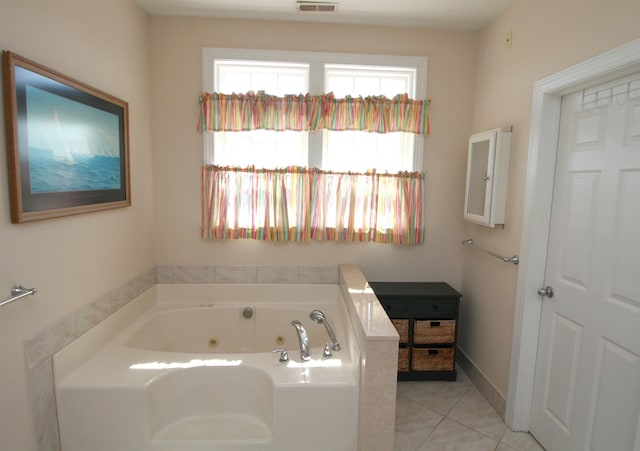 bathroom with tile patterned flooring and a washtub