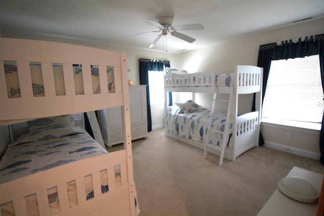 bedroom featuring light carpet and ceiling fan