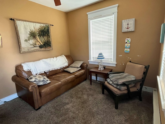 carpeted living room with a ceiling fan and baseboards