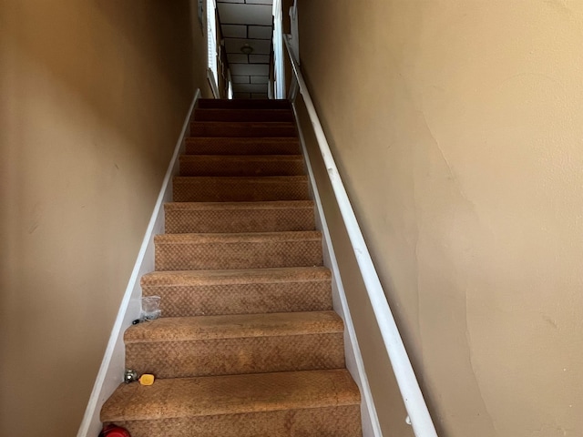 stairway featuring baseboards