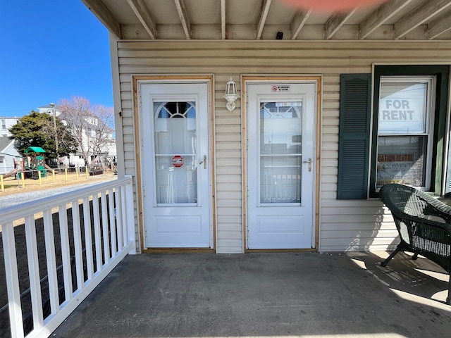 view of exterior entry featuring a porch